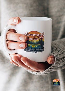 Woman holding coffee mug with adventures along the way logo